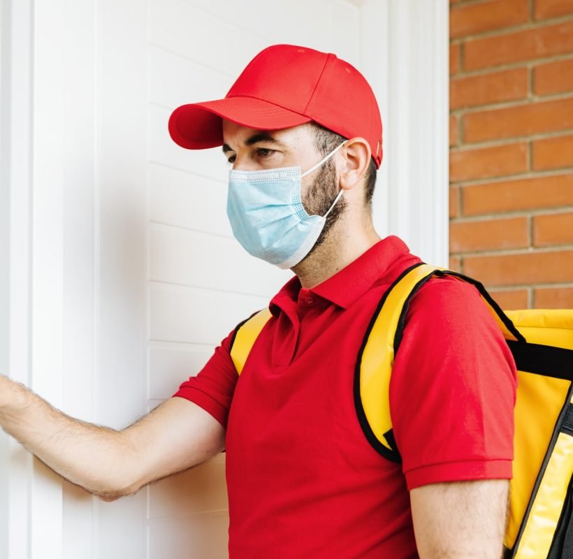 young-hispanic-delivery-food-man-in-face-mask-ringing-the-doorbell-food-delivery-concept.jpg